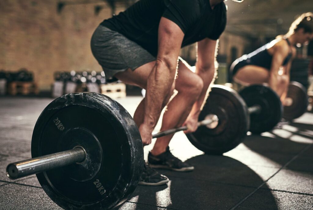 Weightlifter easing training soreness with routine massage
